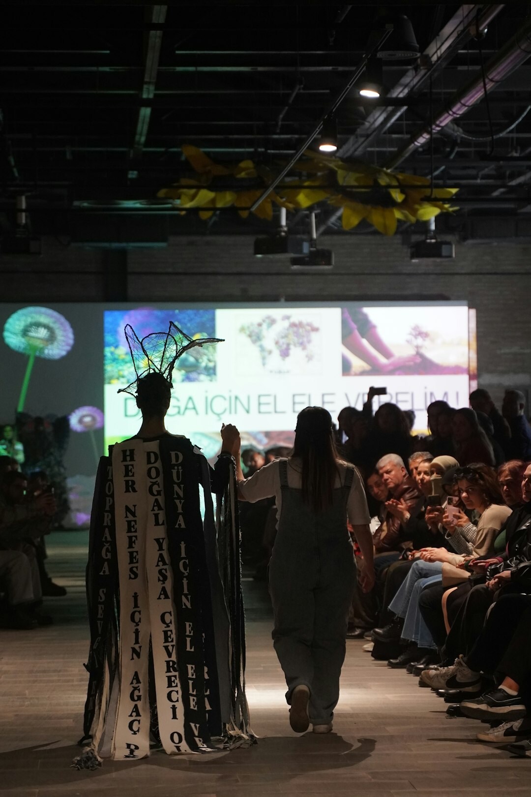 Fashion runway detail with dramatic lighting and flowing fabric