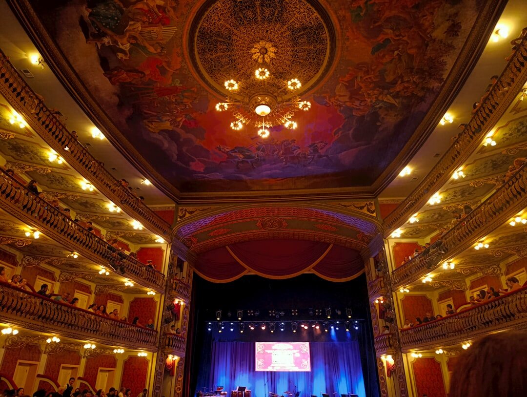 Elegant gala evening at a historic opera house with soft golden lighting
